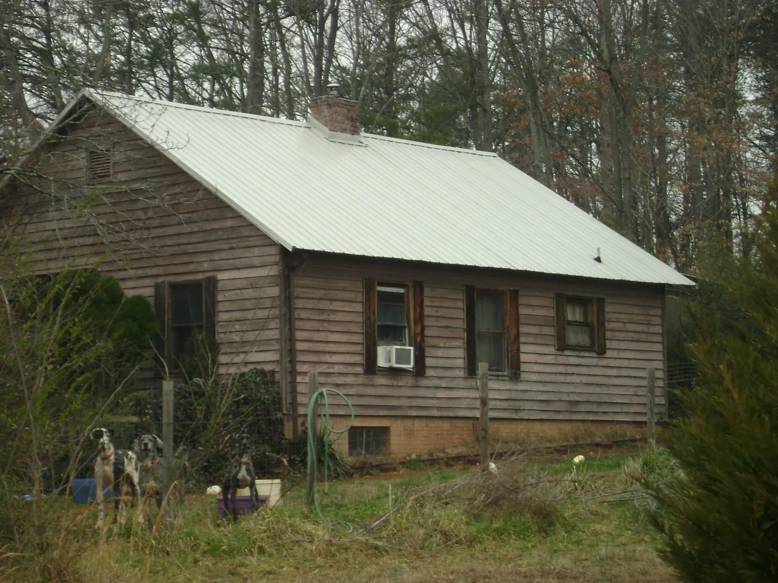 White metal roof on an old wood sided farmhouse, from a Metal Roof Installation job in Glengary